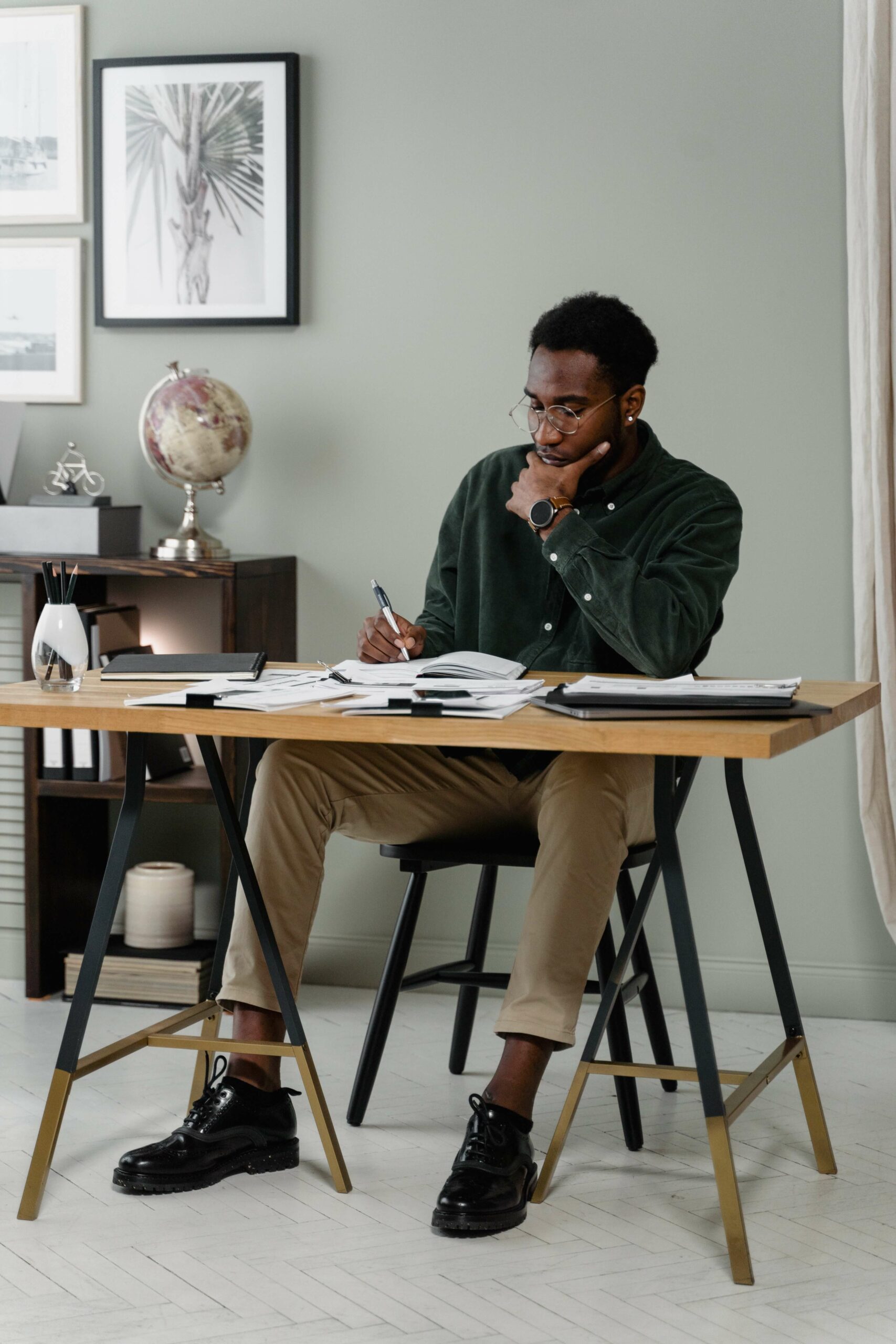 man writing at desk